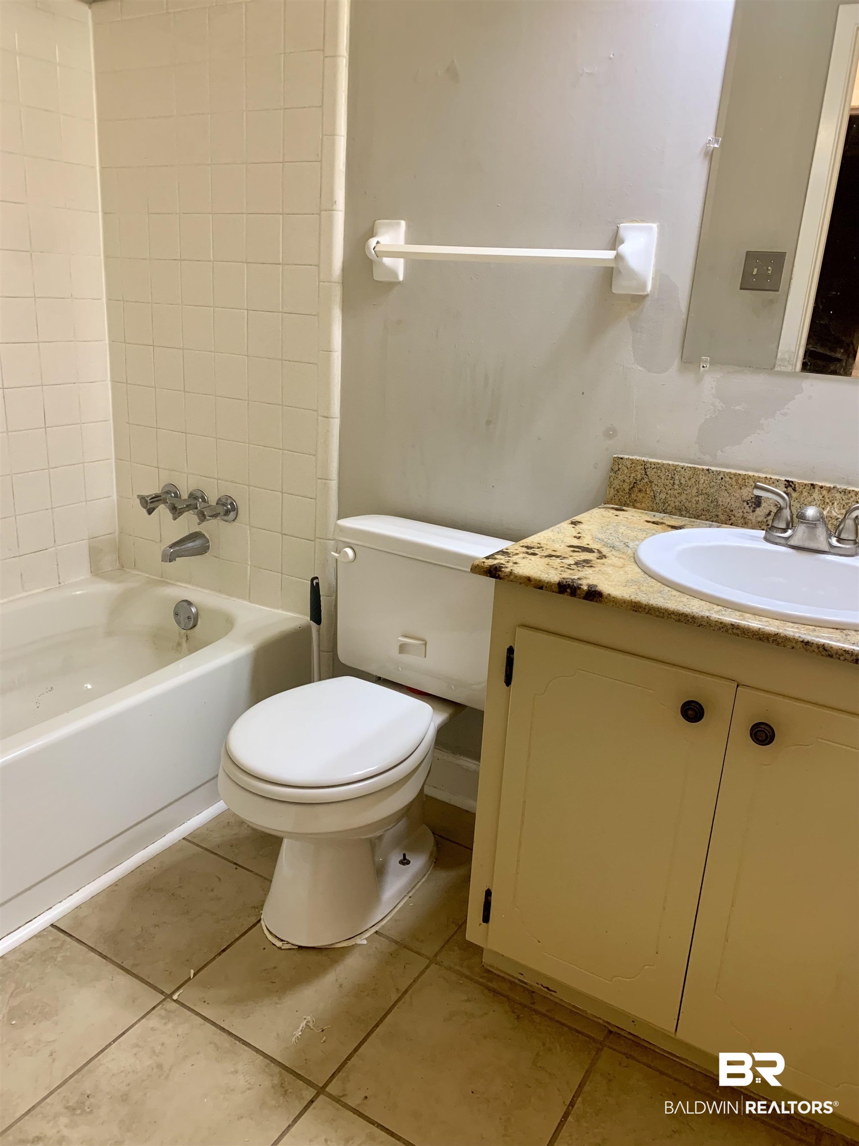 2708 E Road Mobile, AL 36693 - Photo 5 of 12 Full bathroom featuring vanity, tiled shower / bath, tile patterned flooring, and toilet