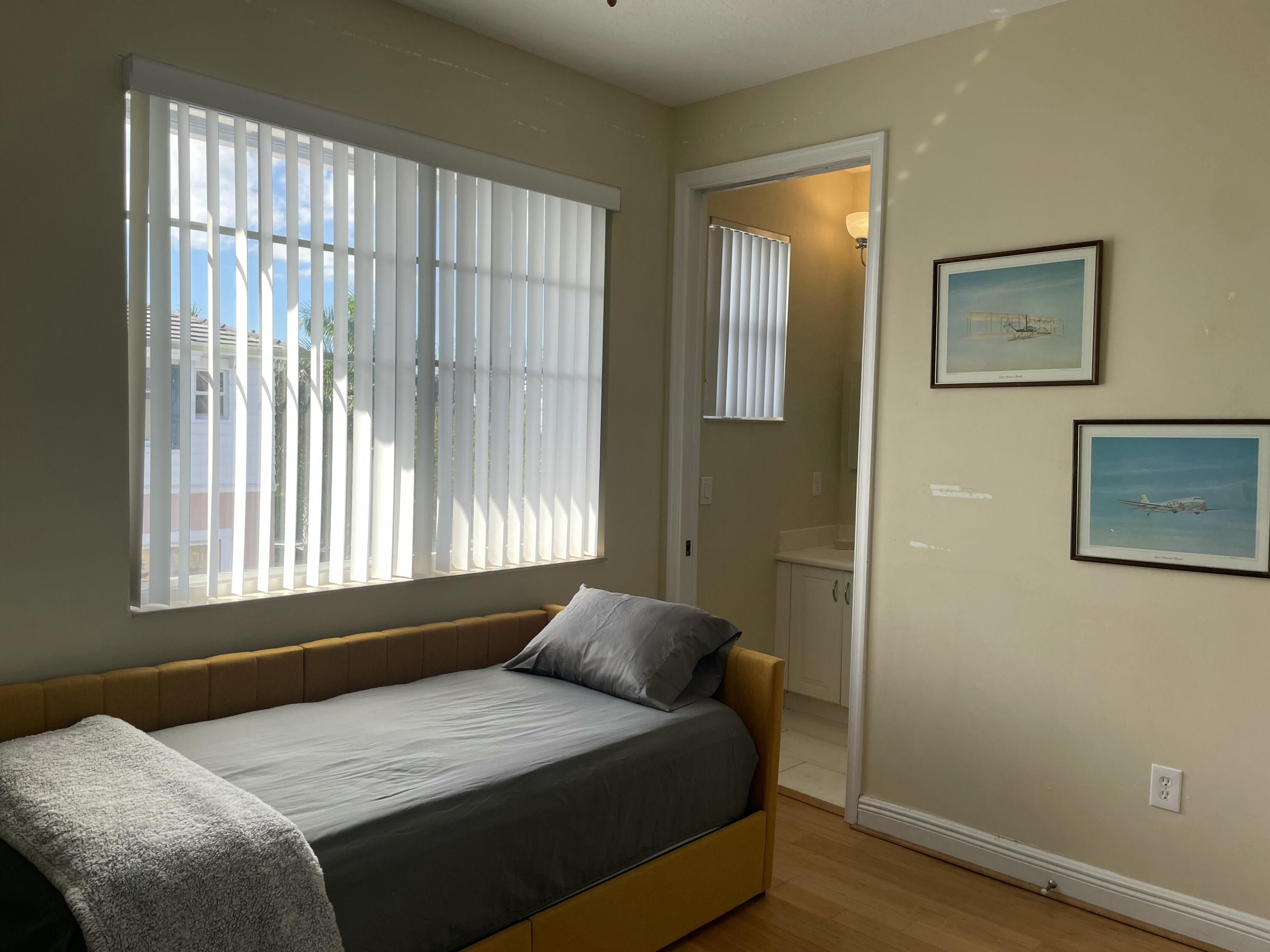 552 North West 39th Circle Boca Raton, FL 33431 - Photo 14 of 33 a bedroom with a bed and a window