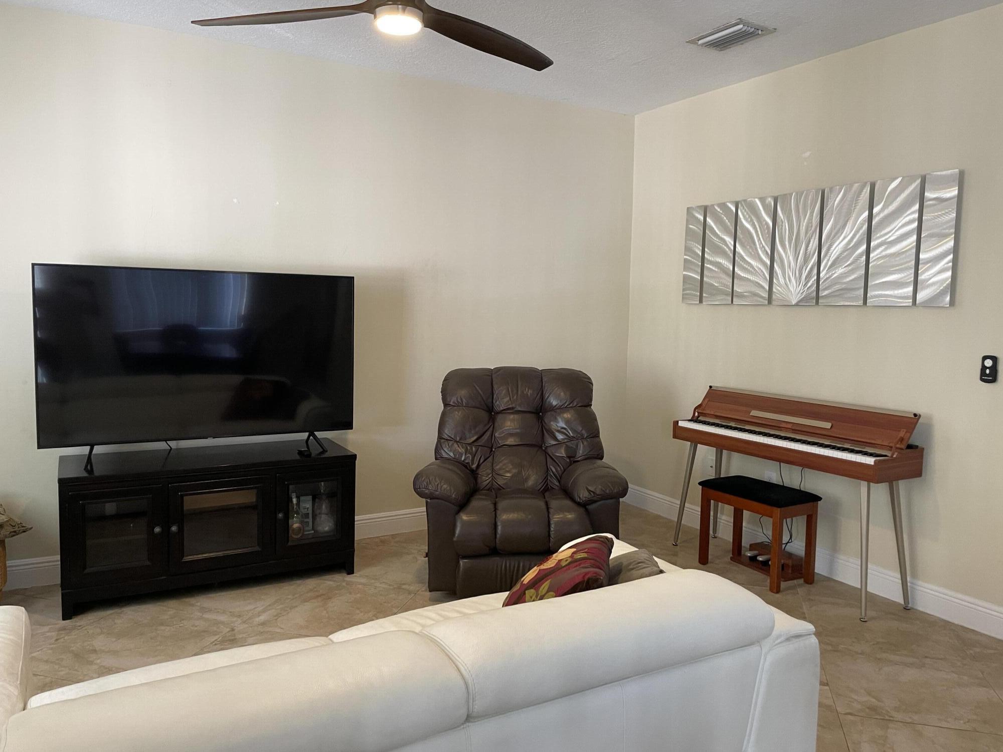 552 North West 39th Circle Boca Raton, FL 33431 - Photo 19 of 33 a living room with furniture and a flat screen tv