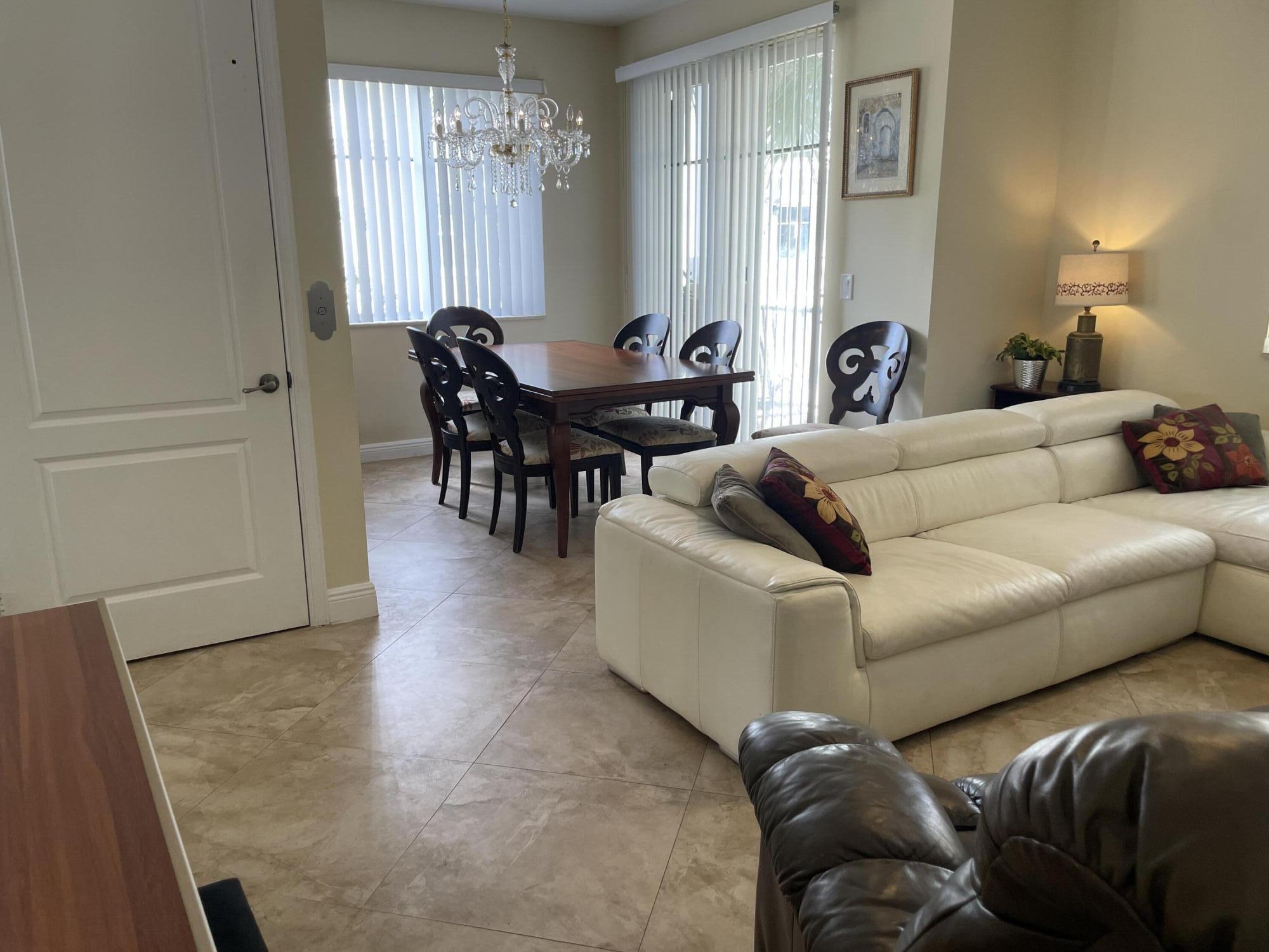 552 North West 39th Circle Boca Raton, FL 33431 - Photo 20 of 33 a living room with furniture and a large window