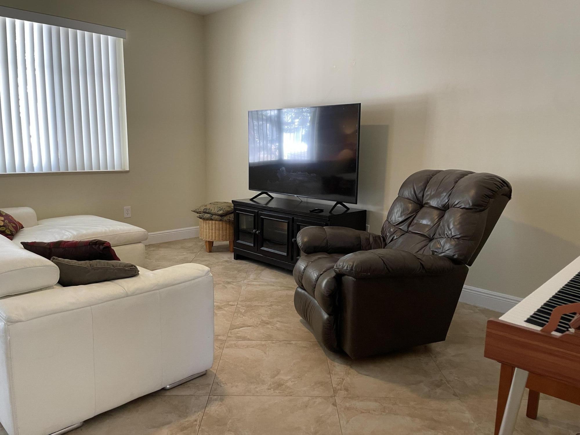 552 North West 39th Circle Boca Raton, FL 33431 - Photo 8 of 33 a living room with furniture and a flat screen tv