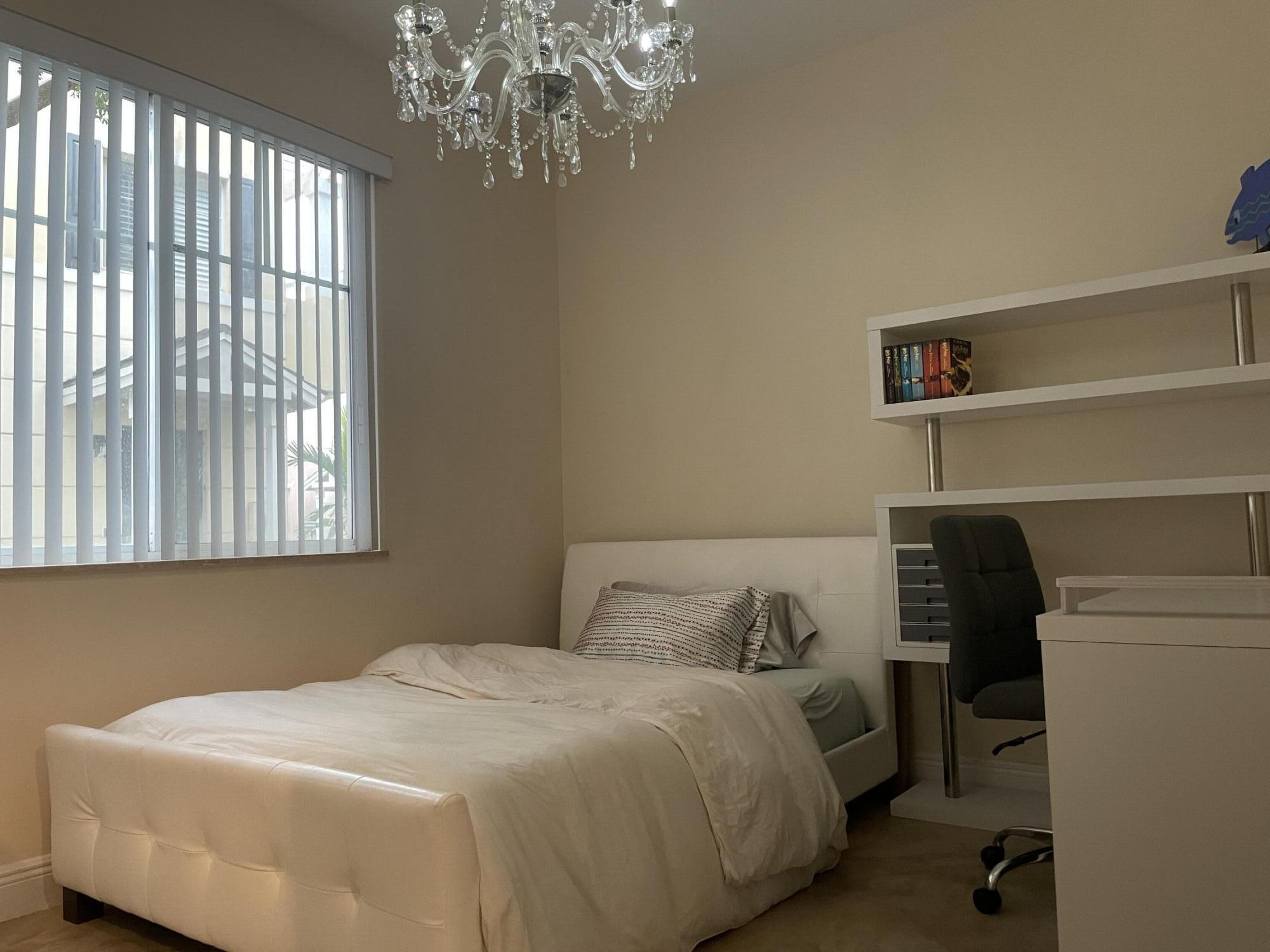 552 North West 39th Circle Boca Raton, FL 33431 - Photo 9 of 33 a bedroom with a bed and a window