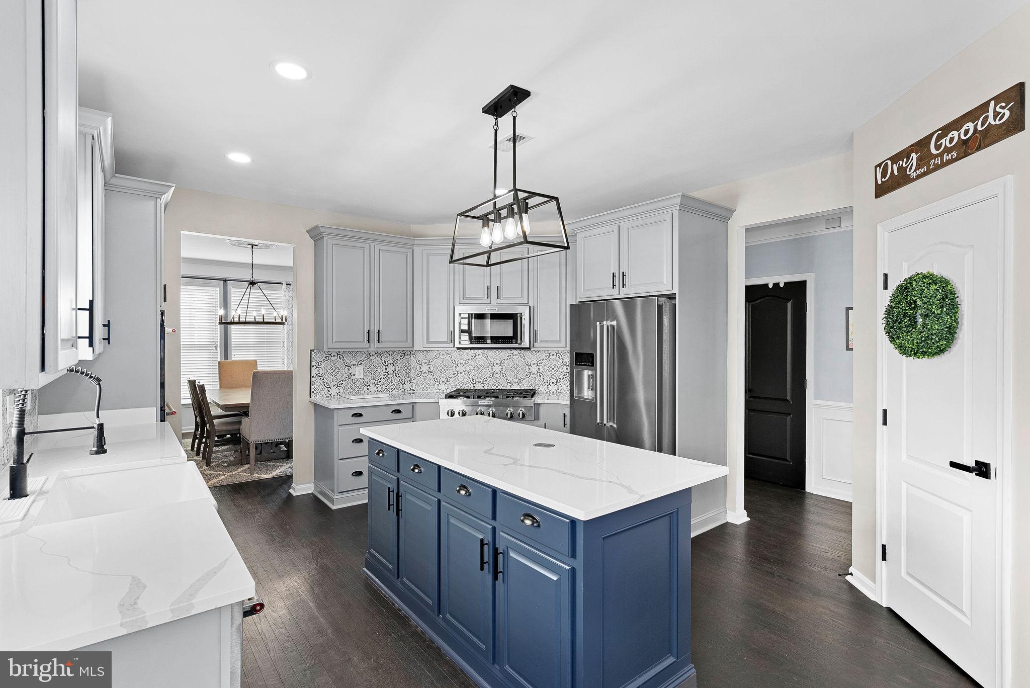 23388 Minerva Drive Brambleton, VA 20148 - Photo 13 of 57 a kitchen with a refrigerator a sink dishwasher and a stove with wooden floor