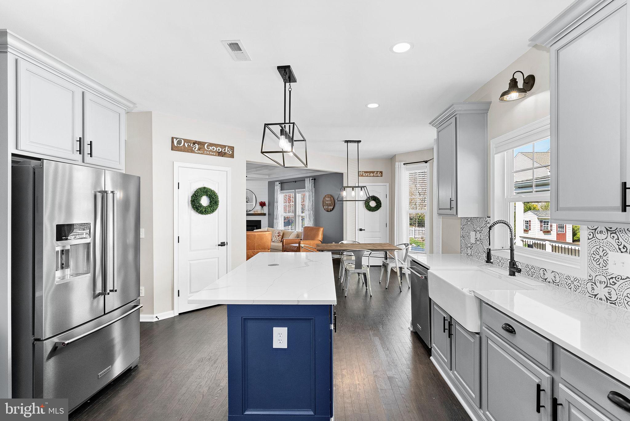 23388 Minerva Drive Brambleton, VA 20148 - Photo 14 of 57 a large kitchen with stainless steel appliances lots of counter space and breakfast area