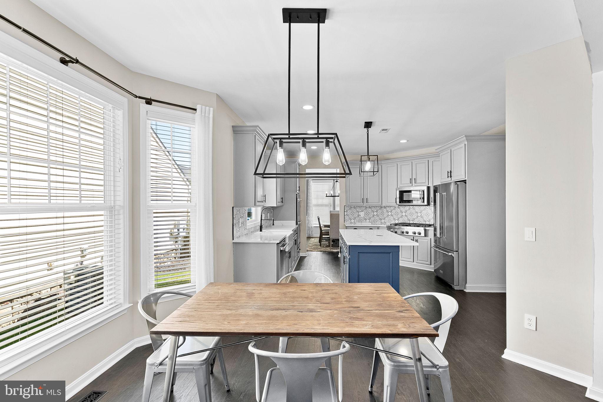 23388 Minerva Drive Brambleton, VA 20148 - Photo 17 of 57 a kitchen with a table and chairs in it