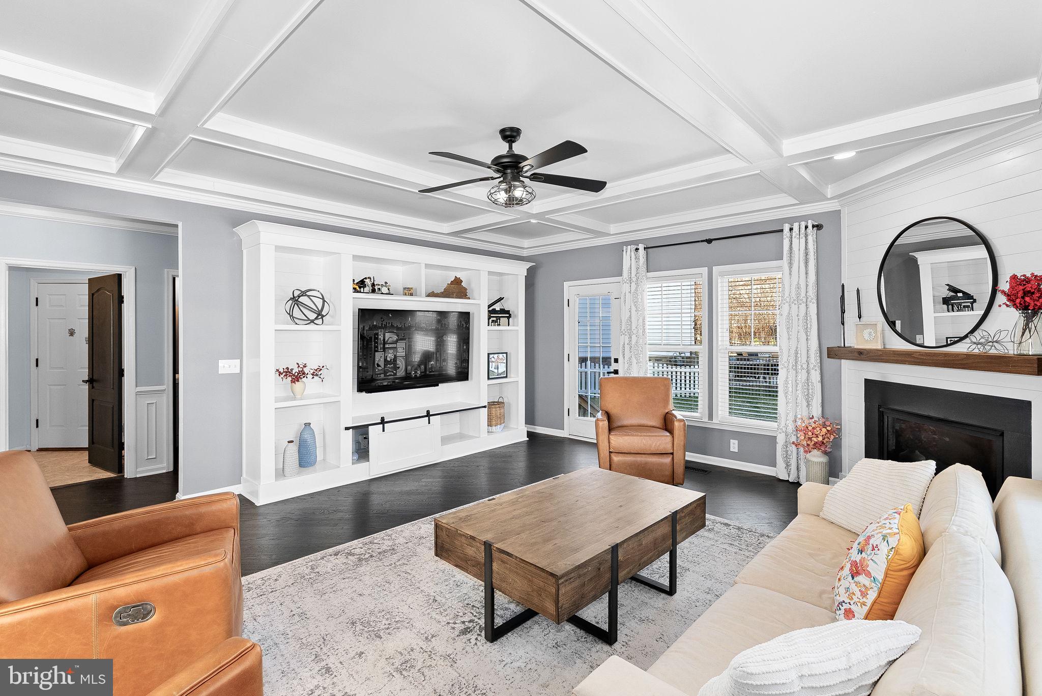 23388 Minerva Drive Brambleton, VA 20148 - Photo 20 of 57 a living room with furniture a fireplace and a flat screen tv
