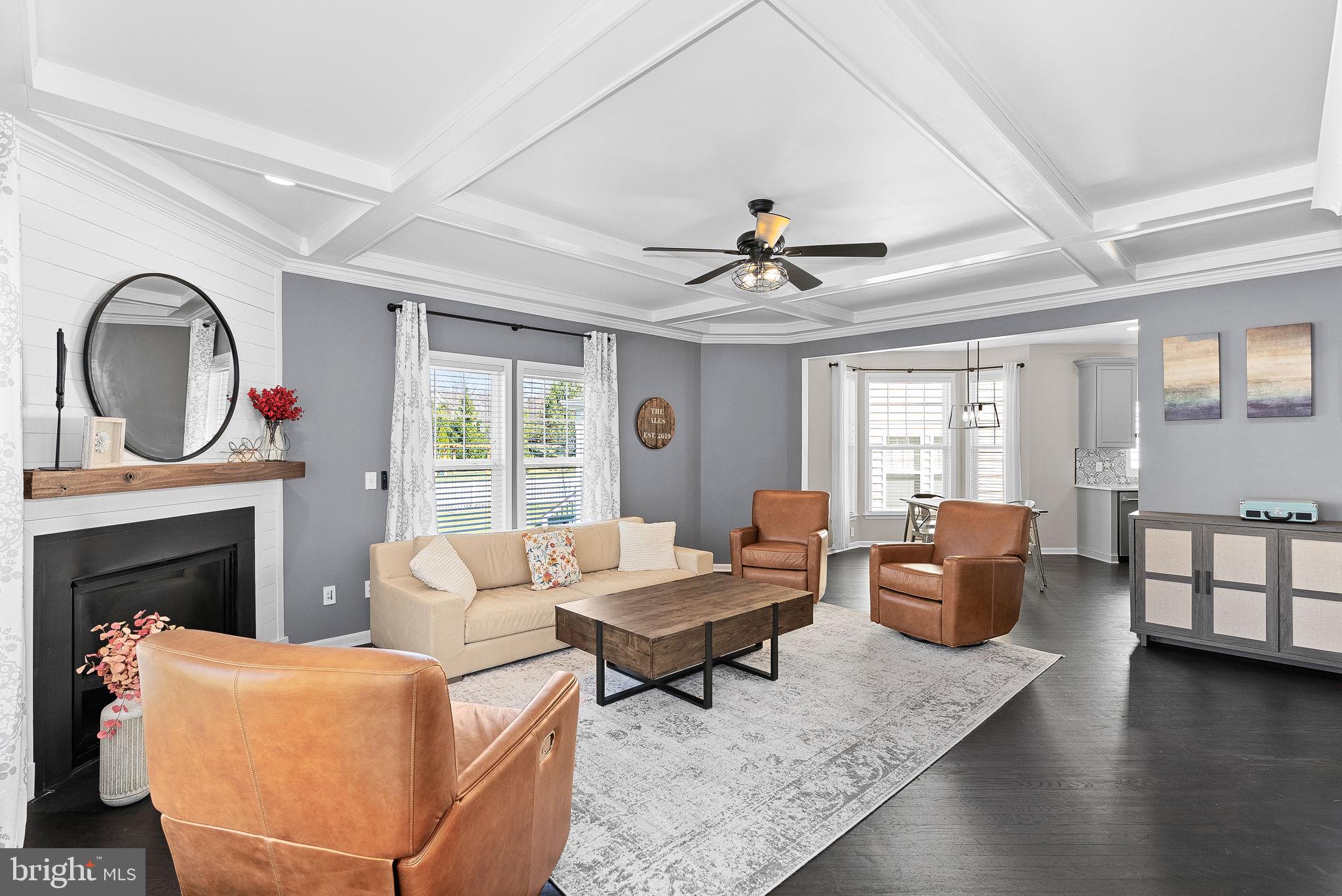 23388 Minerva Drive Brambleton, VA 20148 - Photo 22 of 57 a living room with furniture fireplace and a large window
