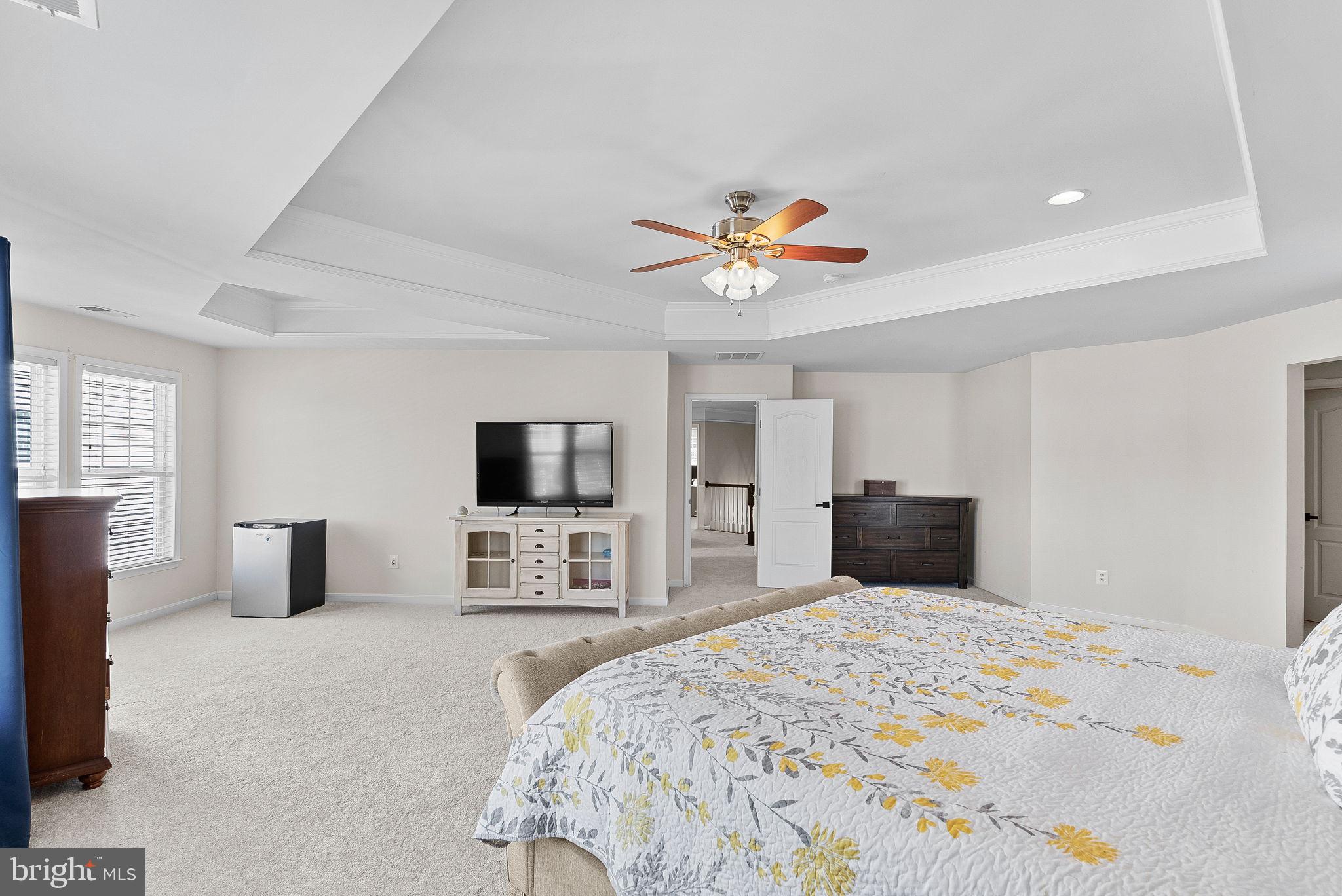 23388 Minerva Drive Brambleton, VA 20148 - Photo 28 of 57 a bedroom with a bed and a flat screen tv