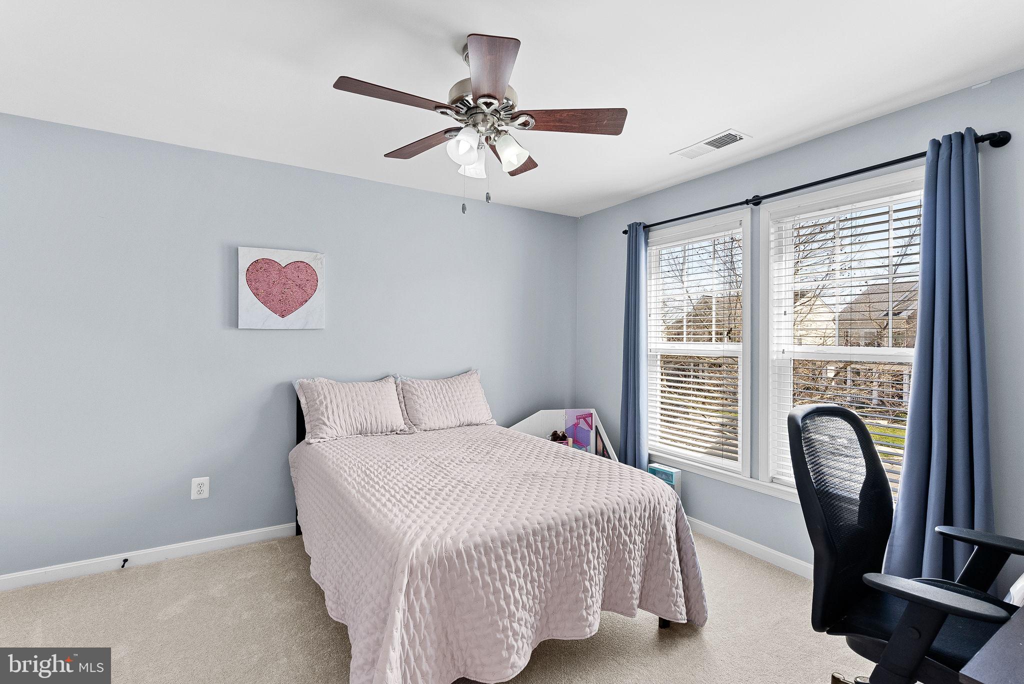 23388 Minerva Drive Brambleton, VA 20148 - Photo 33 of 57 a bedroom with a bed and a chandelier