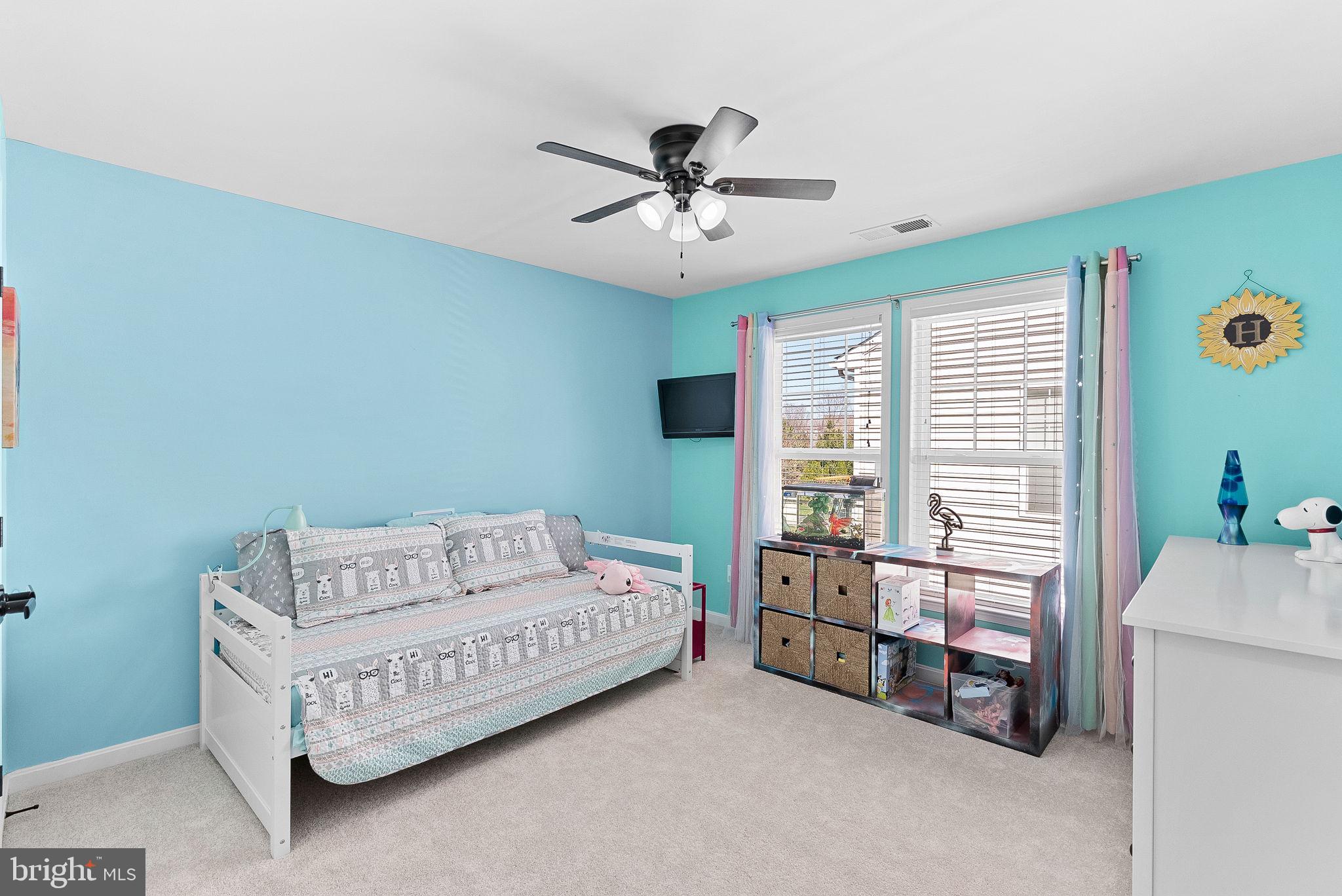 23388 Minerva Drive Brambleton, VA 20148 - Photo 36 of 57 a bedroom with a bed and a chandelier