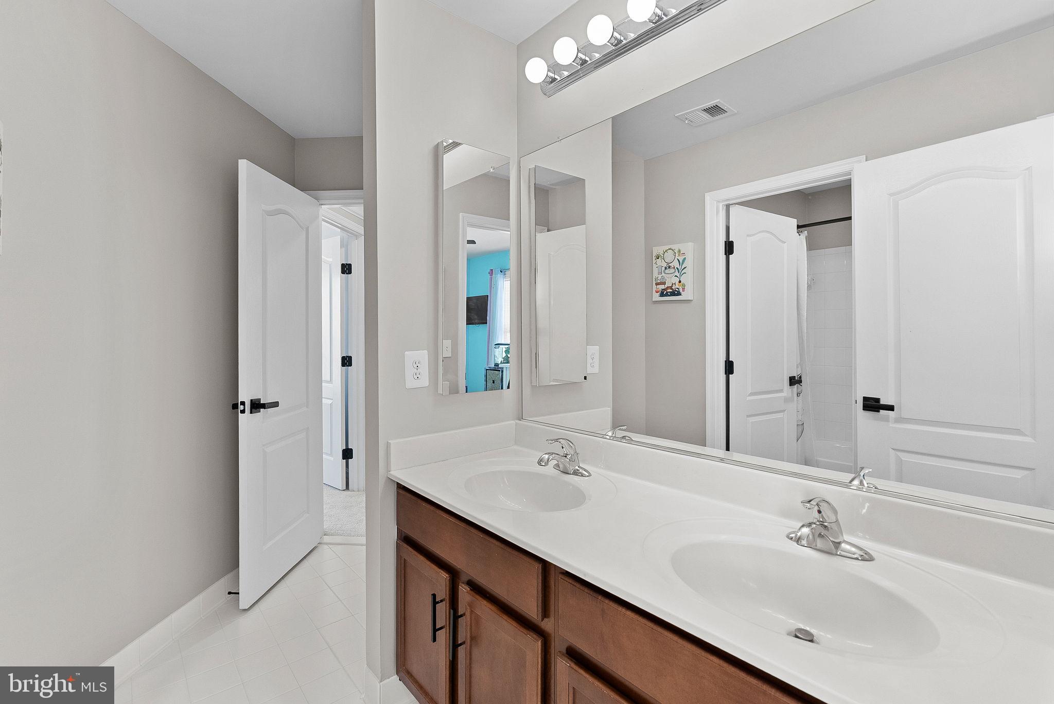 23388 Minerva Drive Brambleton, VA 20148 - Photo 37 of 57 a bathroom with a sink double vanity and a mirror