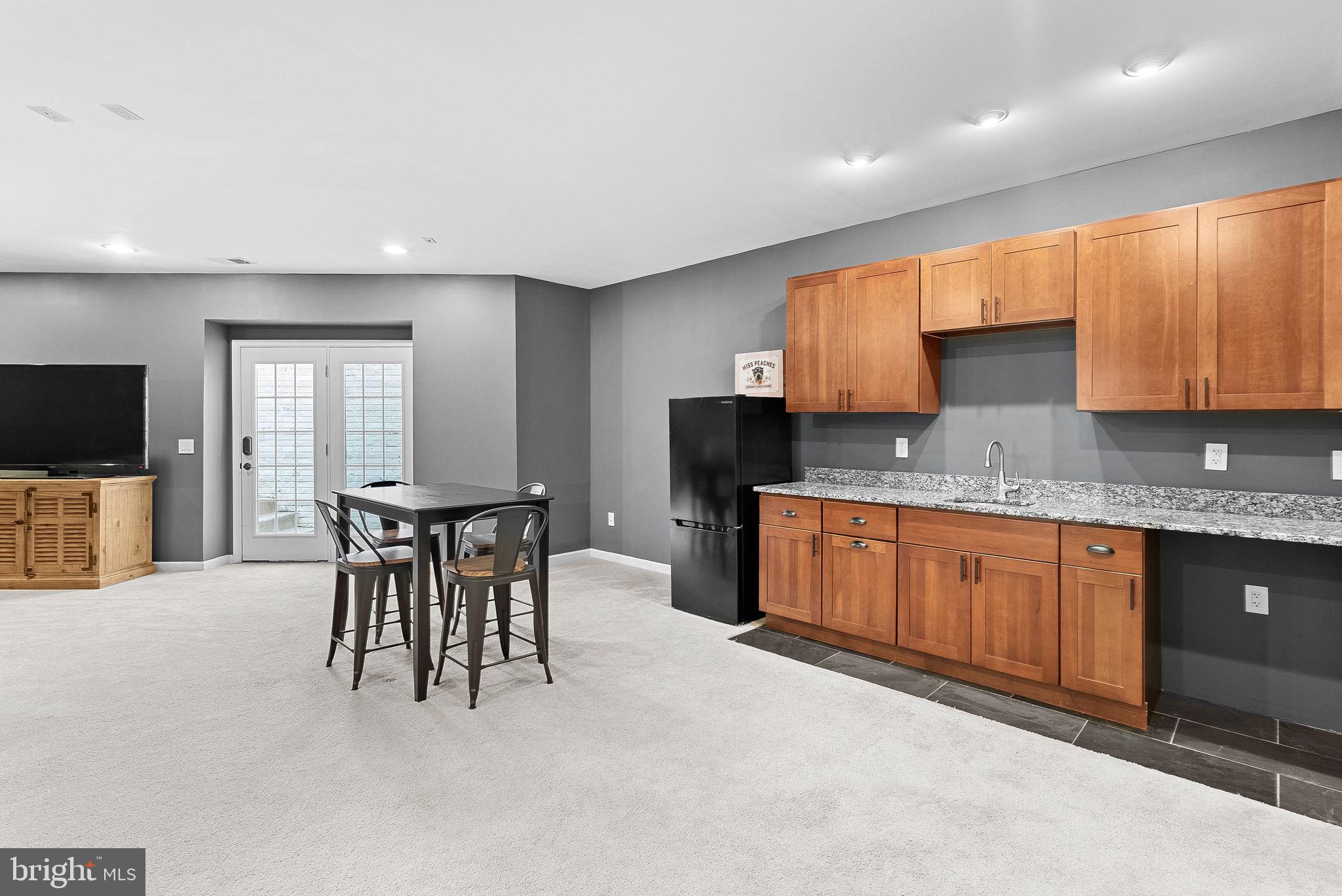 23388 Minerva Drive Brambleton, VA 20148 - Photo 40 of 57 a kitchen with granite countertop a sink cabinets and window