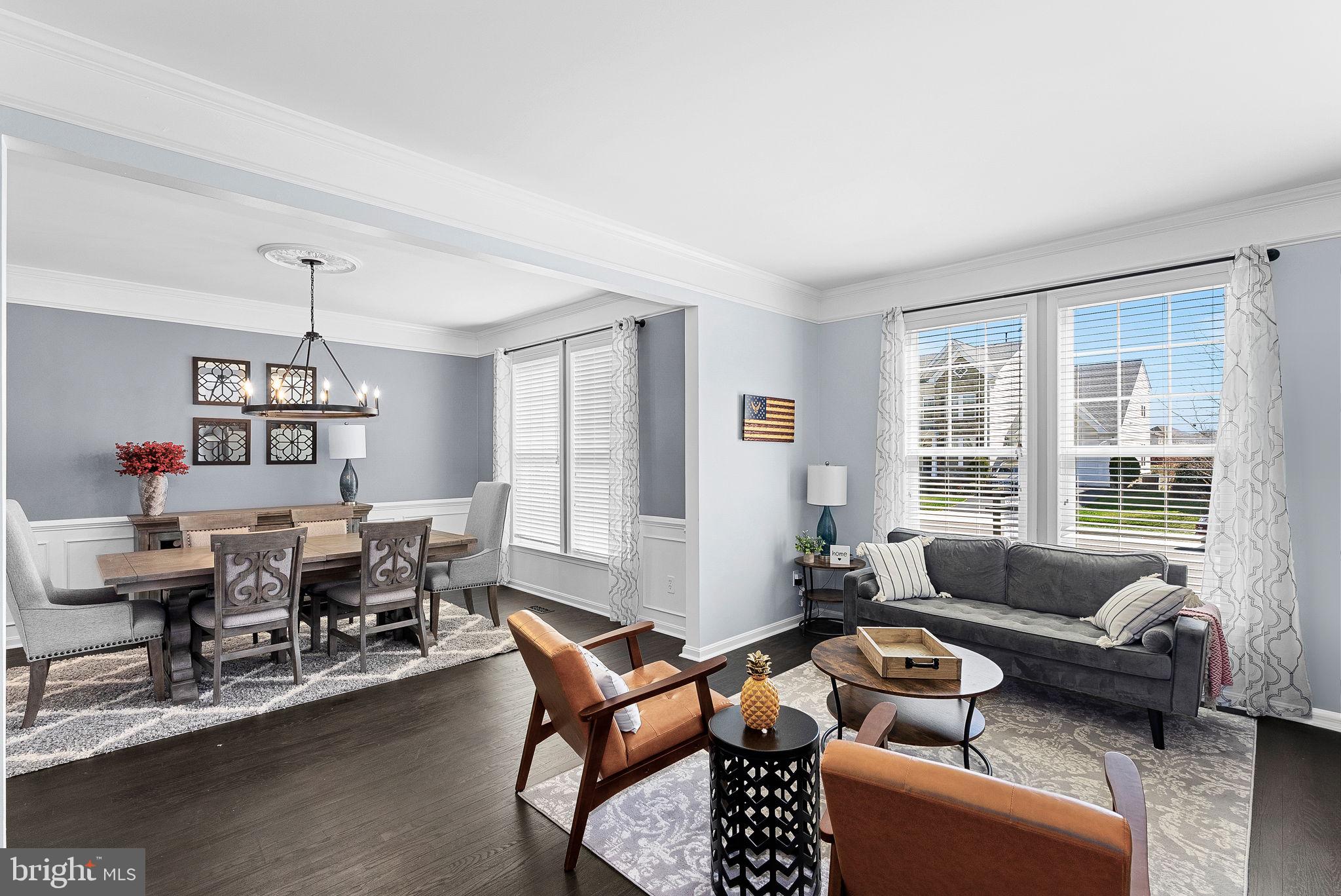 23388 Minerva Drive Brambleton, VA 20148 - Photo 4 of 57 a living room with furniture a dining table and a window