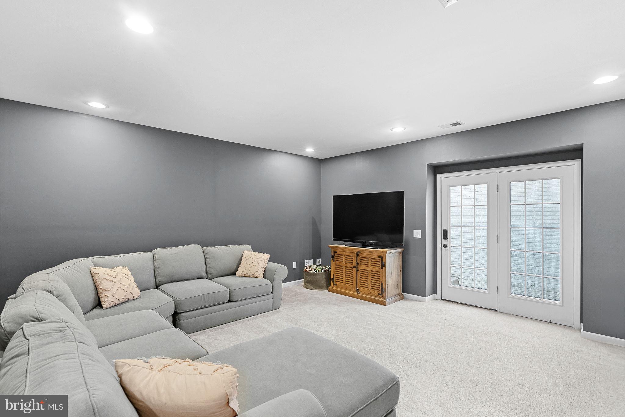 23388 Minerva Drive Brambleton, VA 20148 - Photo 42 of 57 a living room with furniture and a flat screen tv