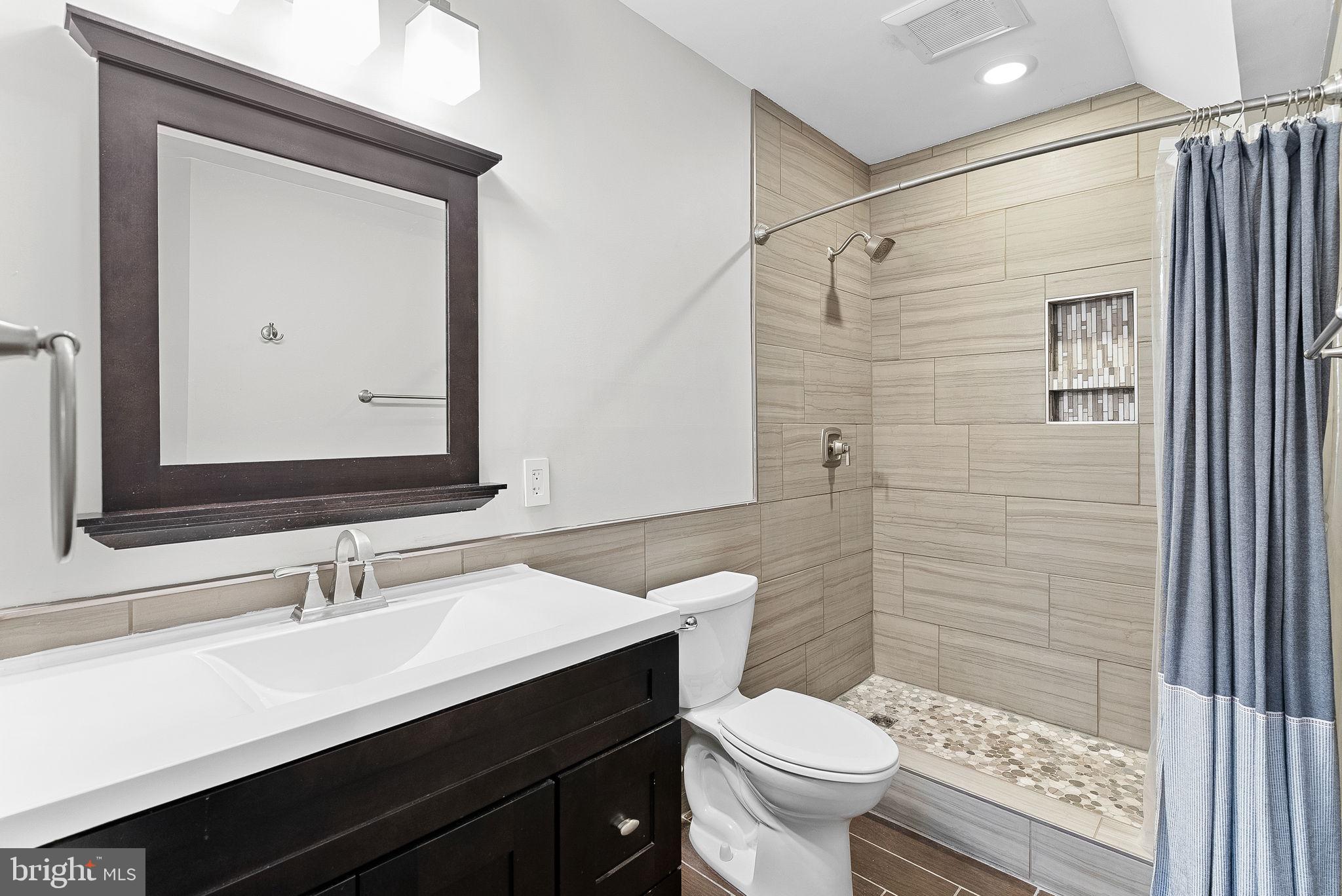 23388 Minerva Drive Brambleton, VA 20148 - Photo 45 of 57 a bathroom with a sink a toilet a shower and a mirror