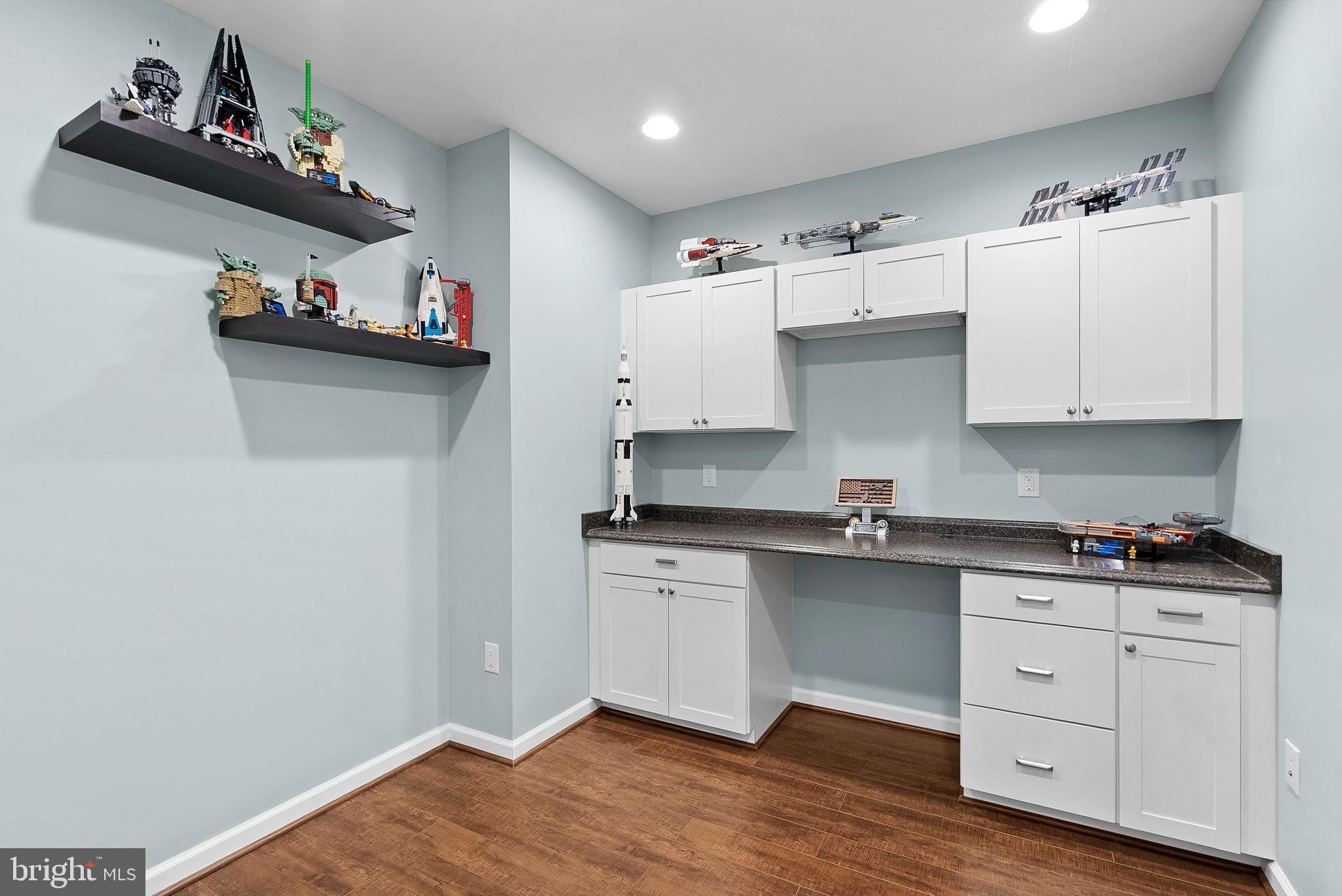 23388 Minerva Drive Brambleton, VA 20148 - Photo 48 of 57 a kitchen with cabinets and wooden floor