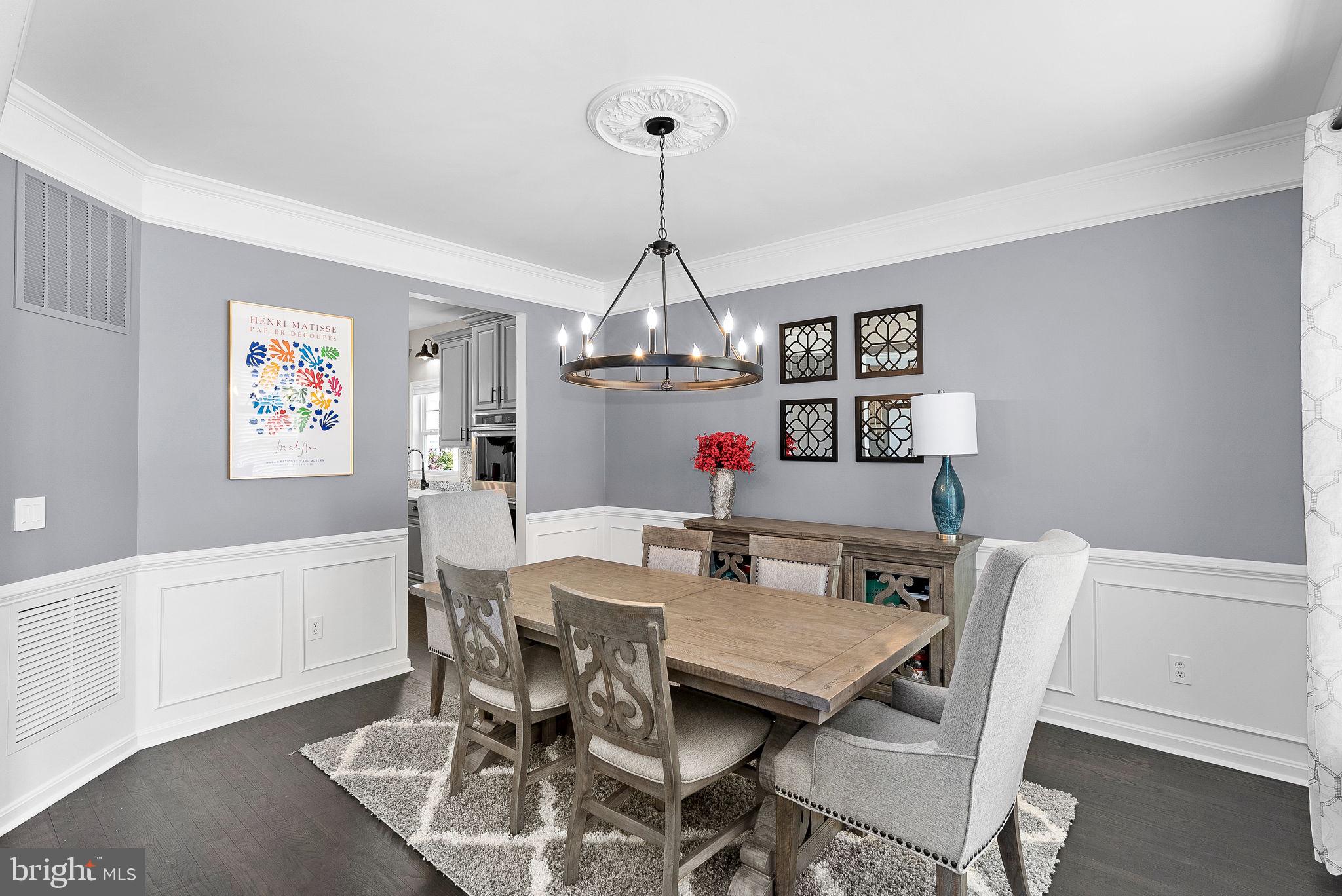 23388 Minerva Drive Brambleton, VA 20148 - Photo 7 of 57 a view of a dining room with furniture window and wooden floor