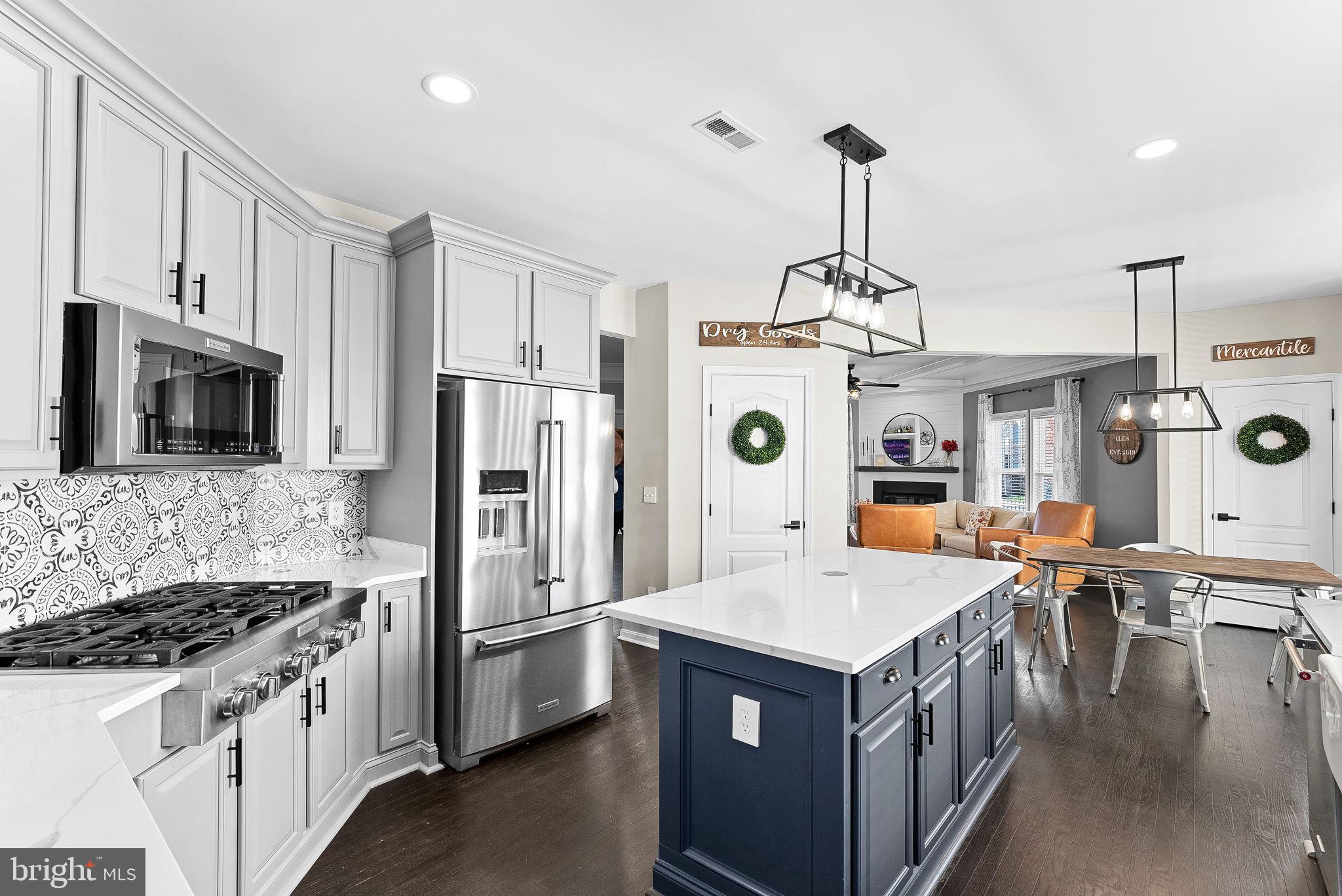 23388 Minerva Drive Brambleton, VA 20148 - Photo 9 of 57 a kitchen that has a lot of stainless steel appliances
