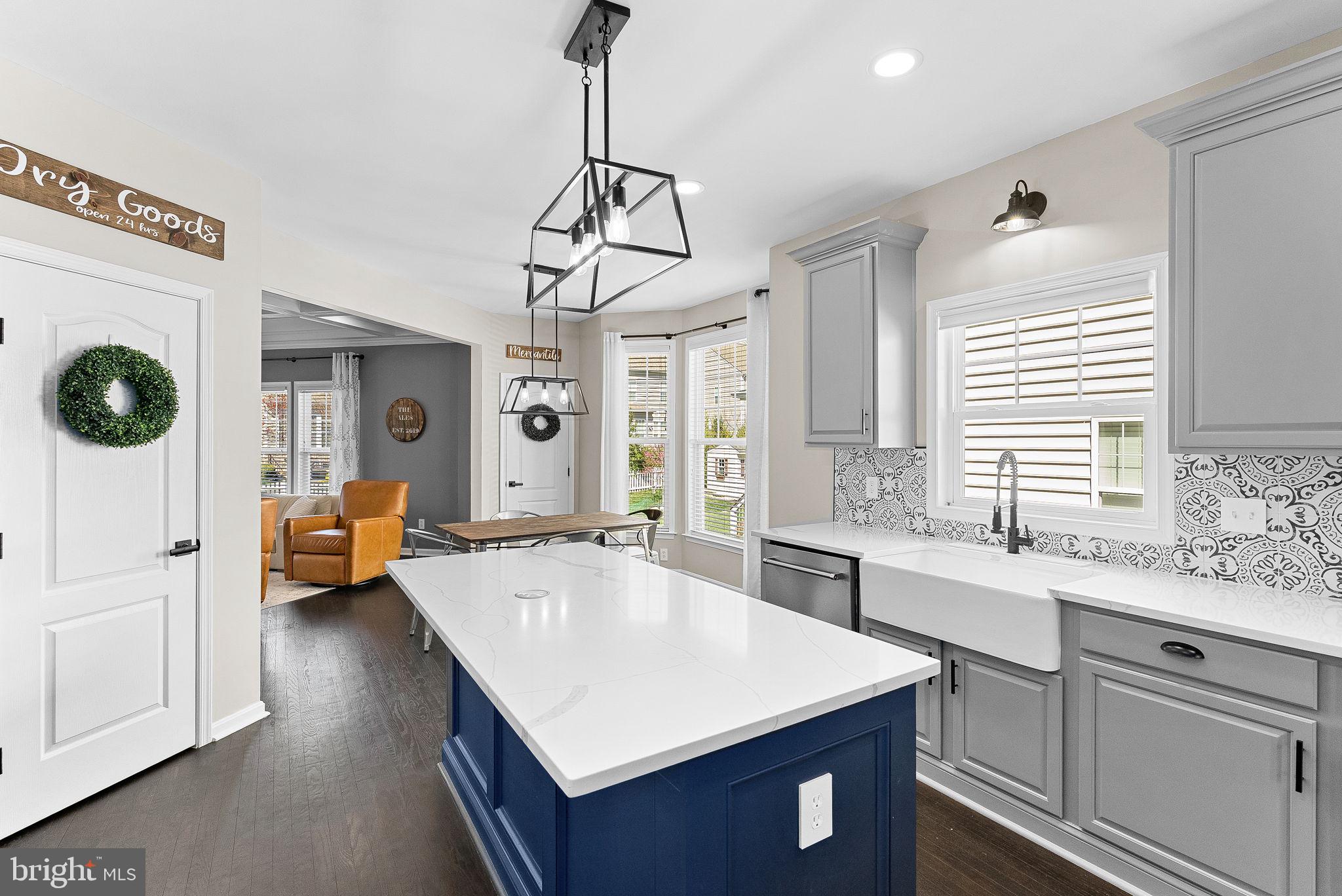 23388 Minerva Drive Brambleton, VA 20148 - Photo 10 of 57 a kitchen with a counter top space a sink a window and living room view