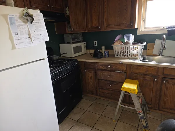 a kitchen with sink cabinets and appliances