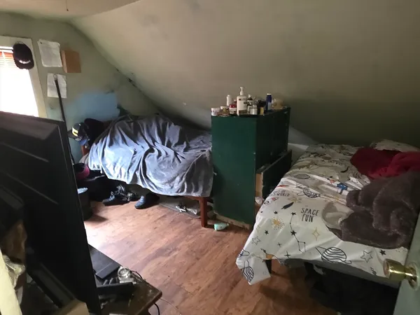 a bed sitting in a bedroom next to a window