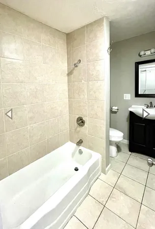 a bathroom with a bathtub and a toilet