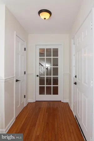 a view of empty room with a window and wooden floor