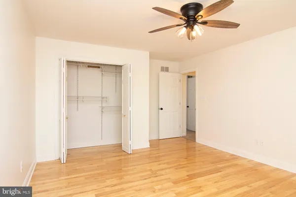 a view of a room with a ceiling fan