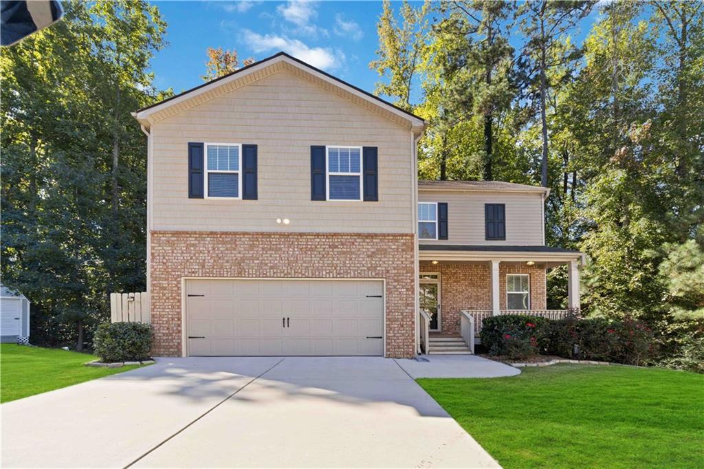 100 Heritage Club Circle Dallas, GA 30132 - Photo 1 of 1 a front view of a house with a yard and garage