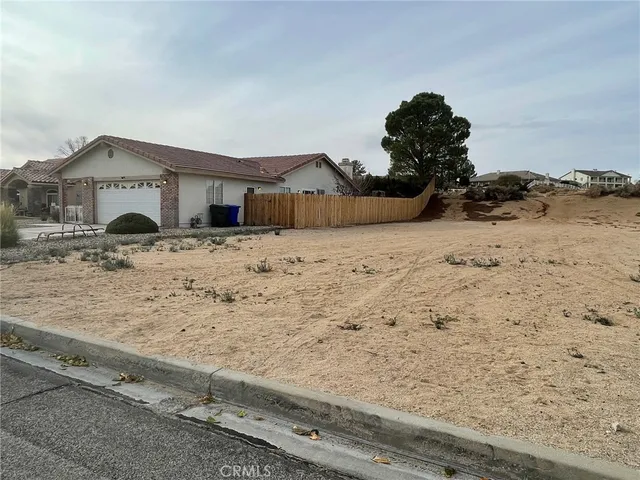 a view of wooden fence and a house