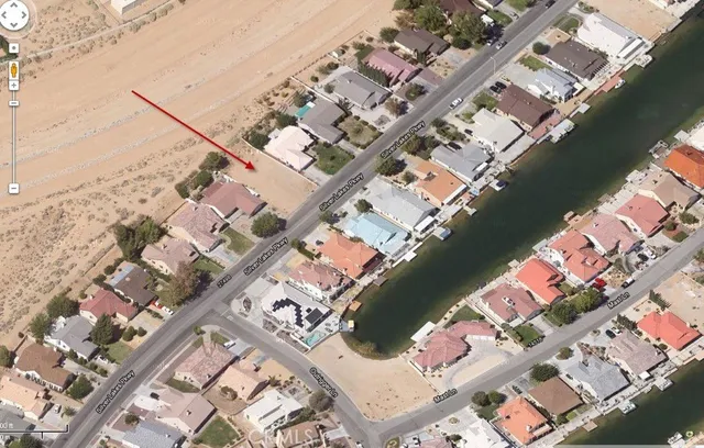 a view of ocean with boats and trees in the background