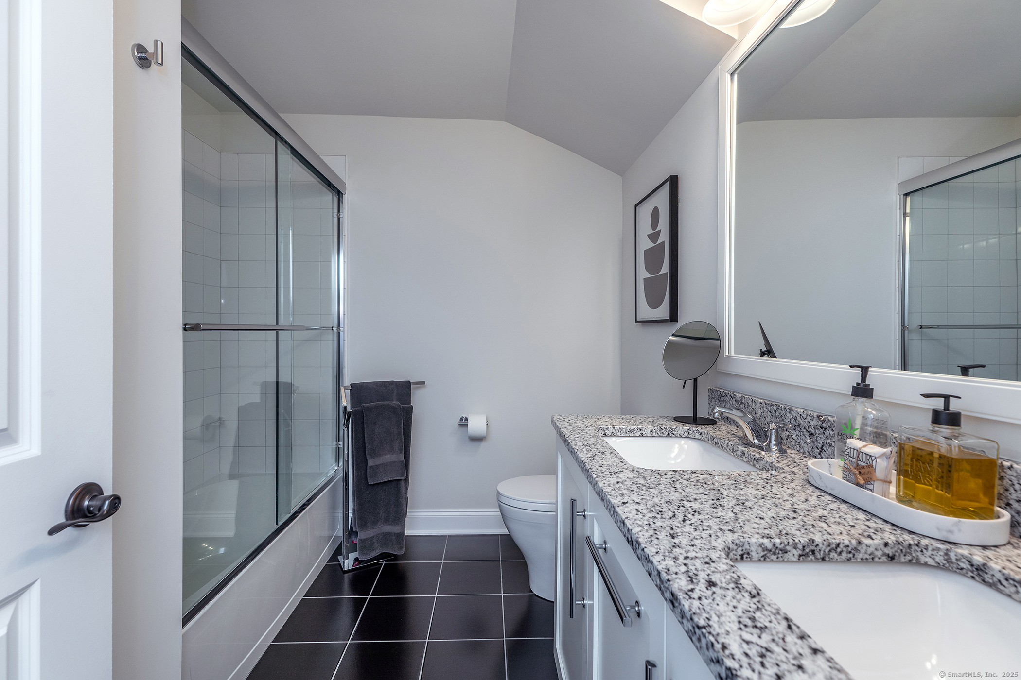 175 Ridgewood Drive, Unit 175 Middlebury, CT 06762 - Photo 17 of 21 a bathroom with a granite countertop sink a mirror and shower