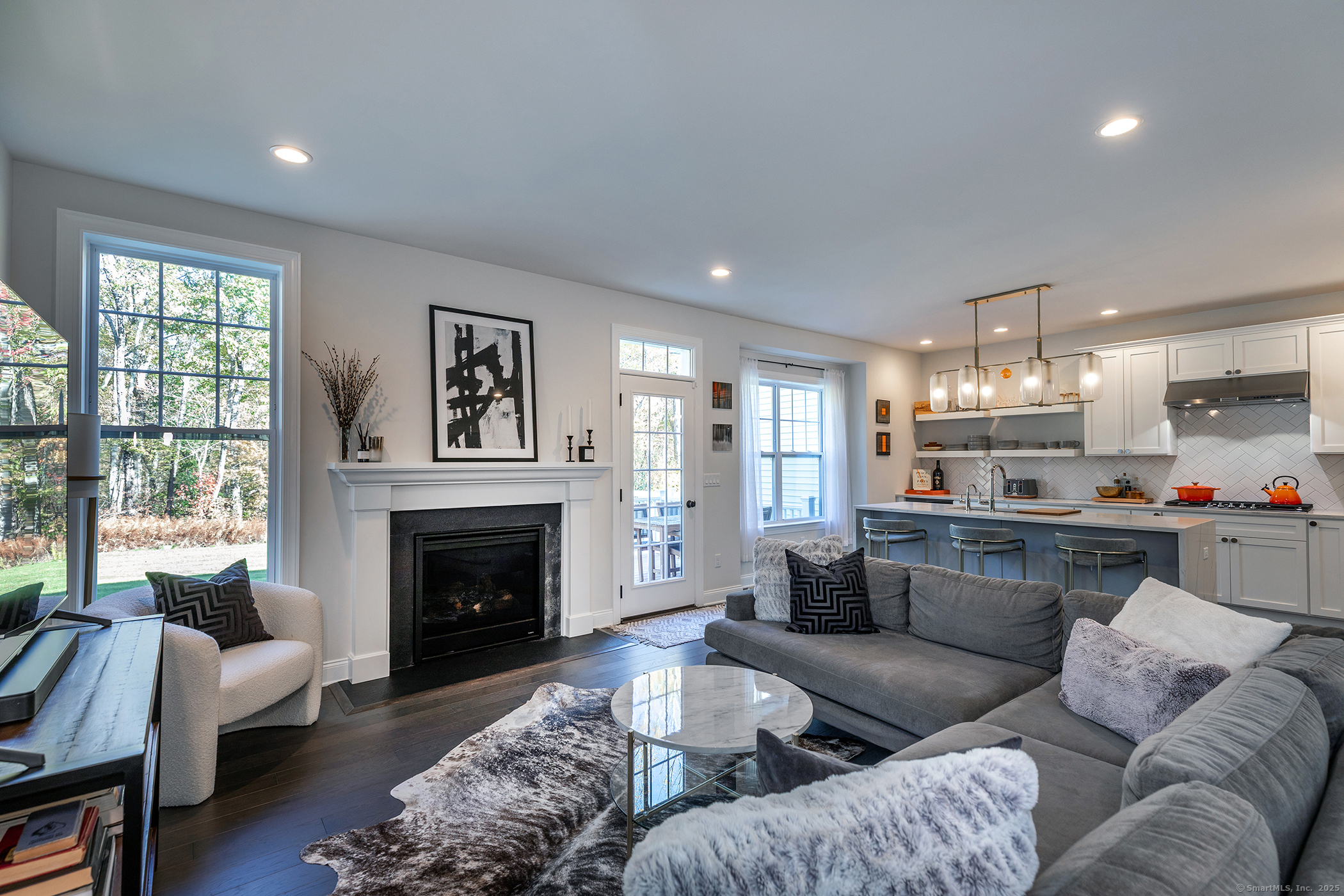 175 Ridgewood Drive, Unit 175 Middlebury, CT 06762 - Photo 7 of 21 a living room with furniture and a fireplace