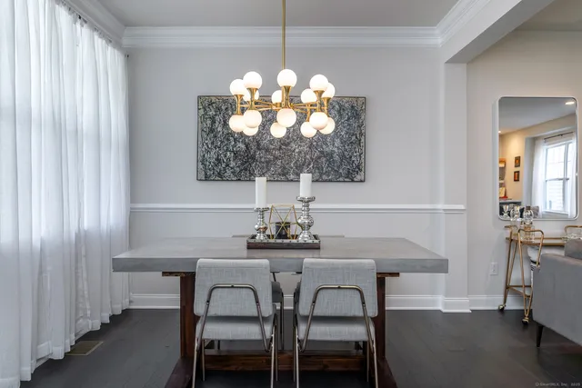 a dining room with furniture and chandelier