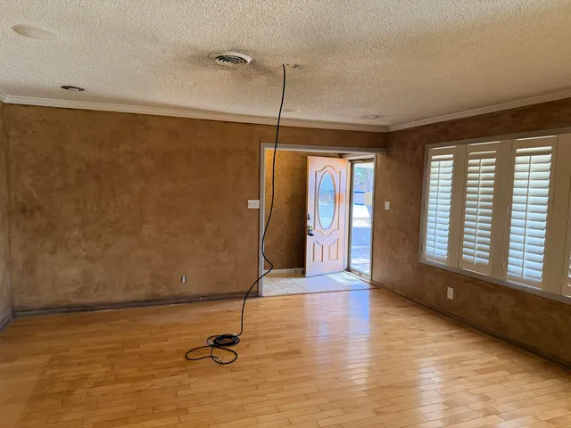 a view of a room with wooden floor and windows