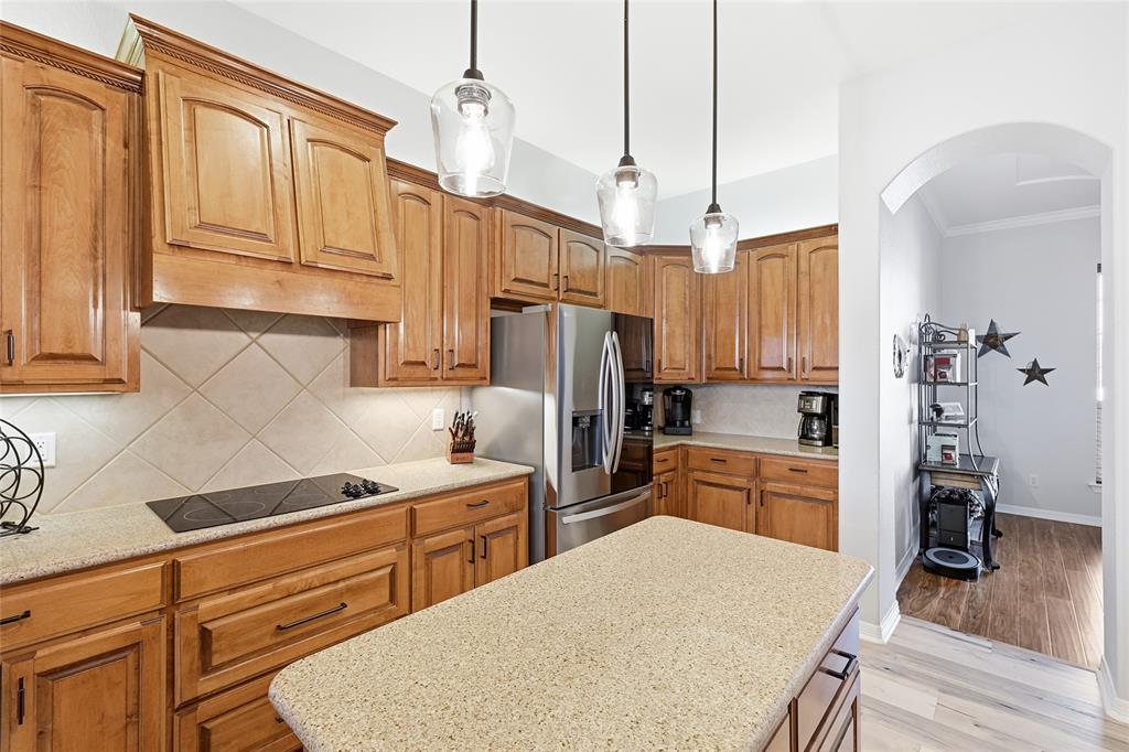 7915 Stone Ridge Drive Northlake, TX 76247 - Photo 14 of 40 a kitchen with stainless steel appliances granite countertop a refrigerator a sink dishwasher a stove and white cabinets with wooden floor