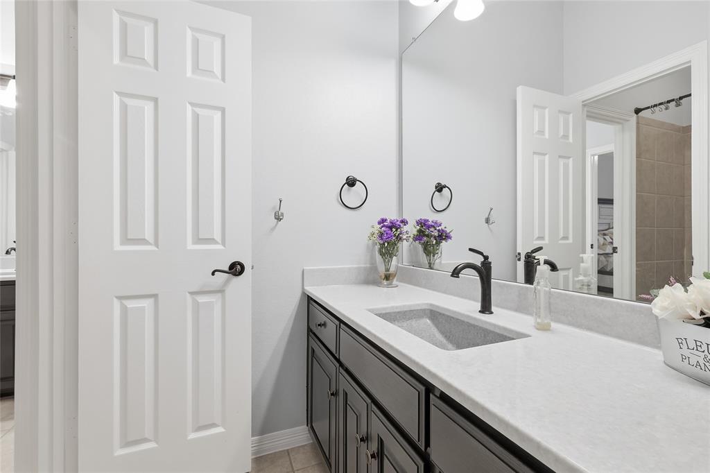 7915 Stone Ridge Drive Northlake, TX 76247 - Photo 22 of 40 a bathroom with a sink and a mirror