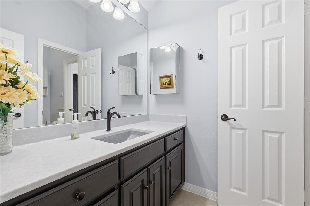 7915 Stone Ridge Drive Northlake, TX 76247 - Photo 24 of 40 a bathroom with a sink and a mirror