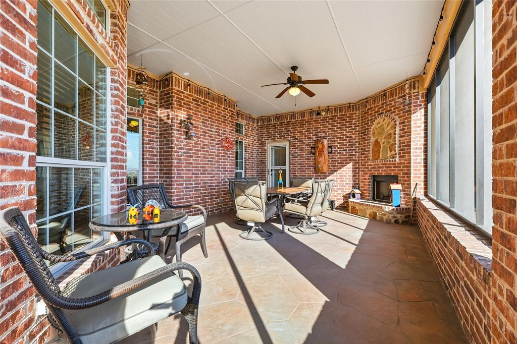 7915 Stone Ridge Drive Northlake, TX 76247 - Photo 26 of 40 a living room with patio furniture and a chandelier