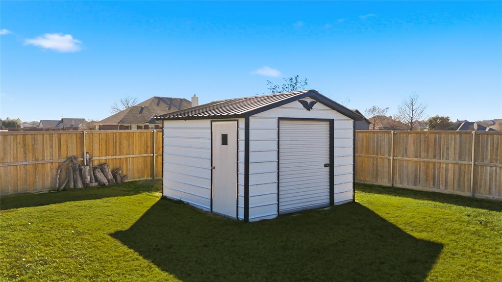 7915 Stone Ridge Drive Northlake, TX 76247 - Photo 29 of 40 a view of a backyard with a small cabin