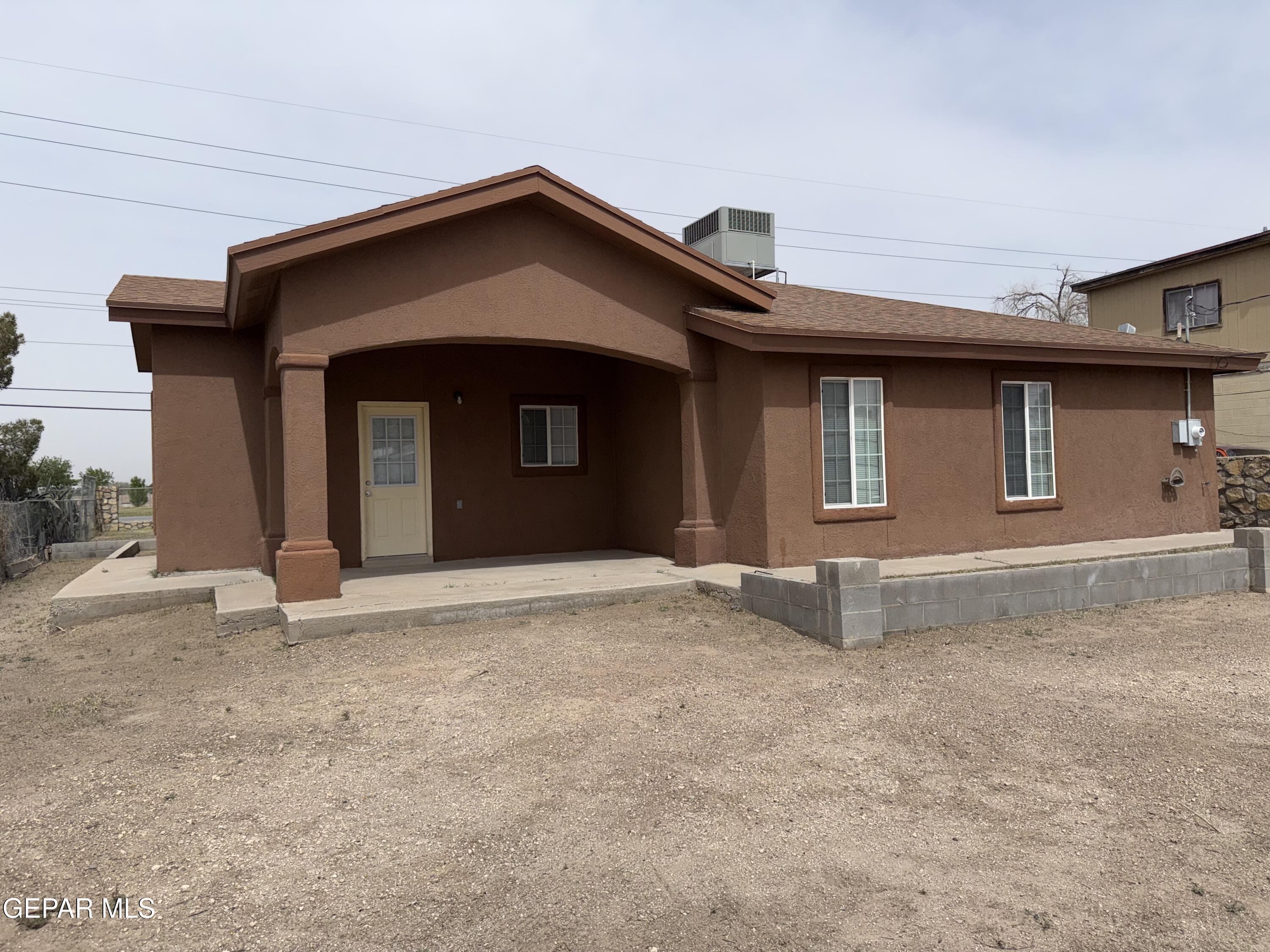 456 Passmore Road Socorro, TX 79927 - Photo 20 of 23 a front view of a house with a yard and garage