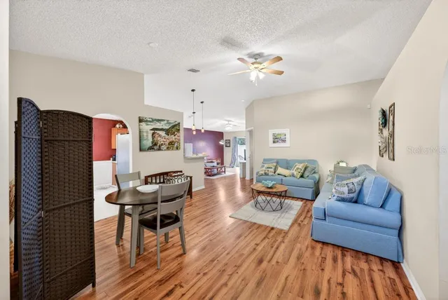 a view of a dining room with furniture and a chandelier