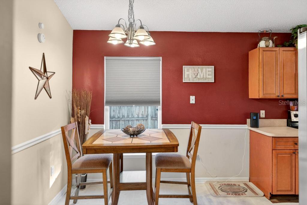 1332 Honey Road Apopka, FL 32712 - Photo 13 of 59 a dining room with furniture and chandelier