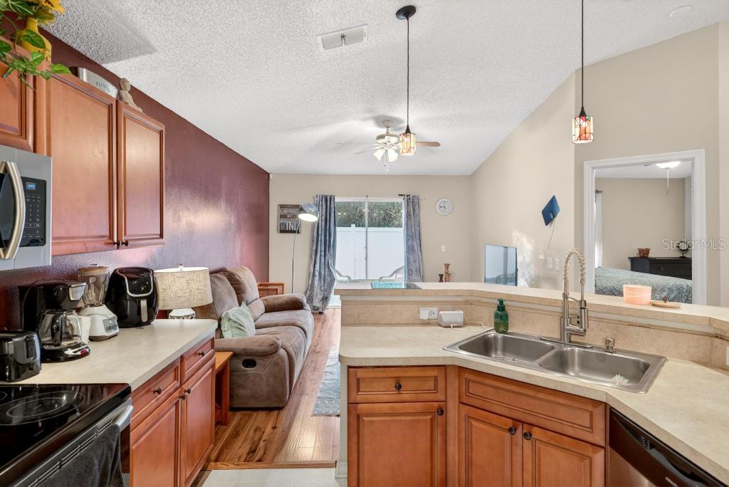 1332 Honey Road Apopka, FL 32712 - Photo 15 of 59 a kitchen with a sink stove and cabinets