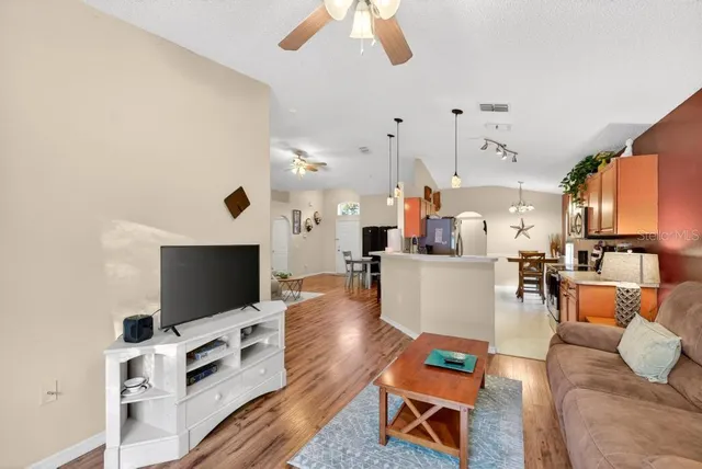 a living room with furniture and a chandelier
