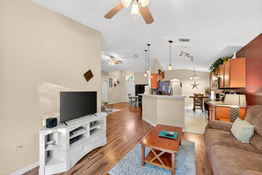 1332 Honey Road Apopka, FL 32712 - Photo 23 of 59 a living room with furniture and a flat screen tv