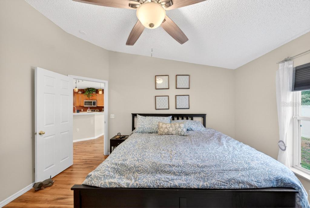 1332 Honey Road Apopka, FL 32712 - Photo 27 of 59 a bedroom with a bed and a chandelier