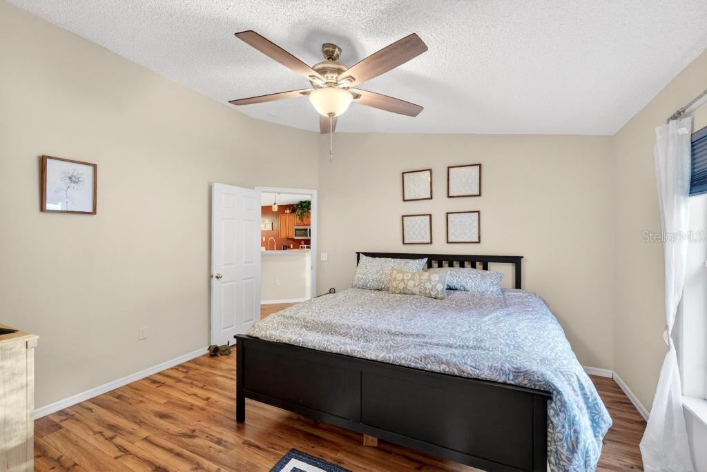 1332 Honey Road Apopka, FL 32712 - Photo 29 of 59 a bedroom with a bed and a chandelier