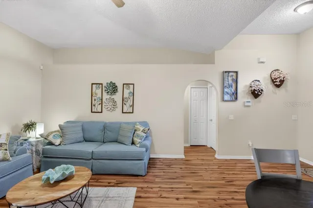 a living room with furniture and a chandelier