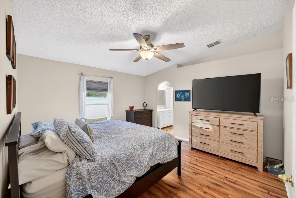 1332 Honey Road Apopka, FL 32712 - Photo 31 of 59 a bedroom with a bed and flat screen tv